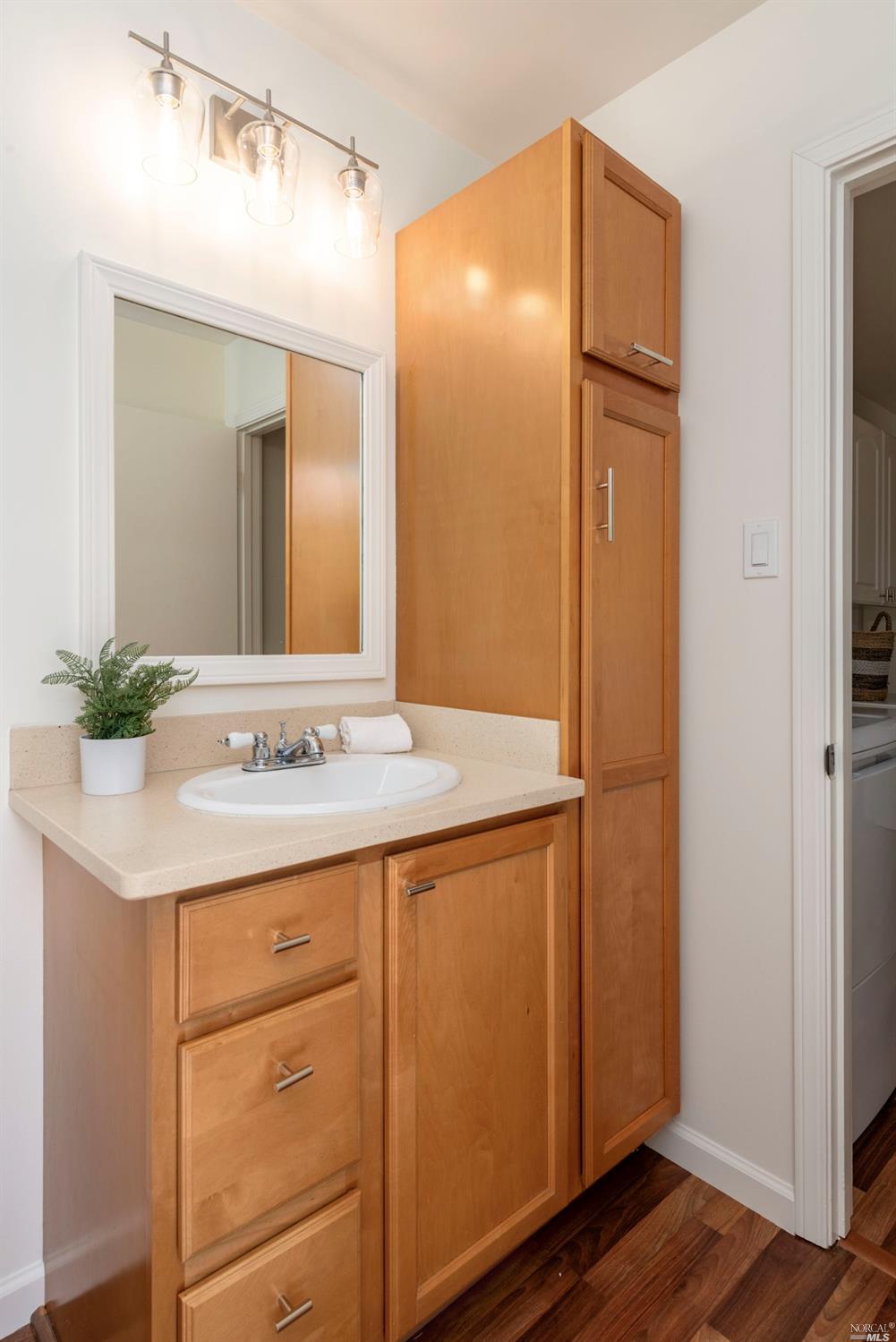 16 Loma Linda Road San Rafael, CA 94901 - Photo 22 of 46 a bathroom with a granite countertop sink and a mirror
