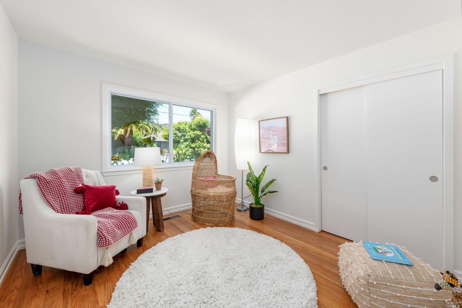16 Loma Linda Road San Rafael, CA 94901 - Photo 25 of 46 a bedroom with a bed and wooden floor