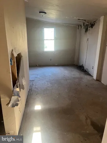 a view of a livingroom with furniture and a window