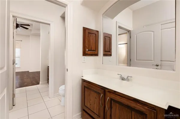 a spacious bathroom with a sink and a mirror