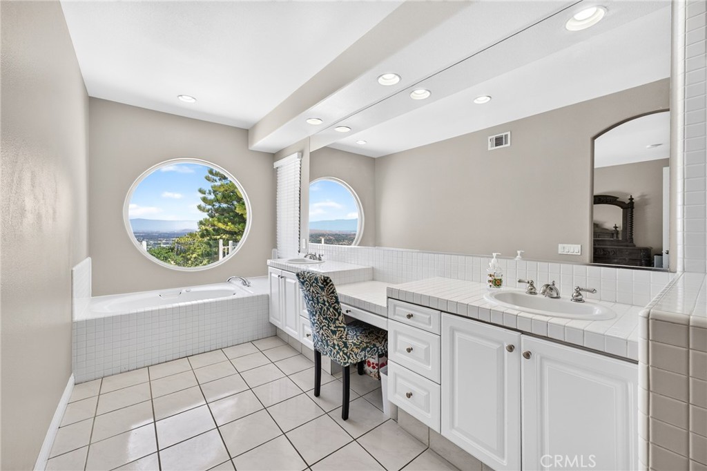 16318 Sun Summit Drive Riverside, CA 92503 - Photo 11 of 47 Primary bathroom with tub, dual sinks and view 16318 sun summit drive, riverside, california 92503