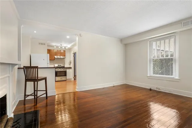 a view of empty room with wooden floor and fireplace