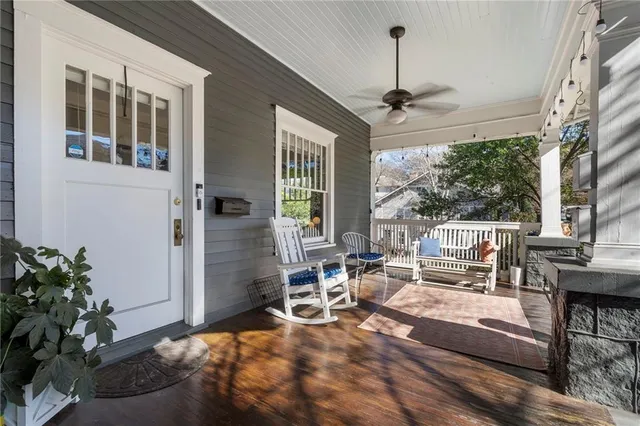 a living room with patio furniture and a potted plant
