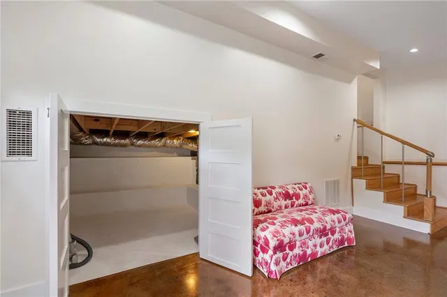 an empty room with wooden floor a fireplace and windows