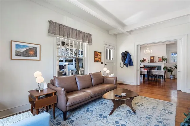 a living room with furniture and wooden floor
