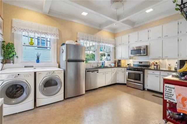 a kitchen with stainless steel appliances granite countertop a stove a sink and a refrigerator