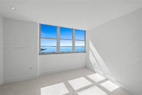 a view of wooden floor and windows in a room