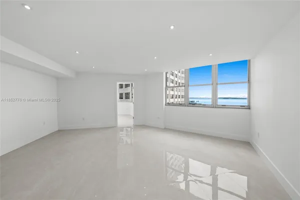 a view of an empty room with a window