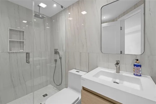 a bathroom with a sink toilet and shower