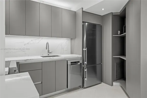 a kitchen with a sink and refrigerator