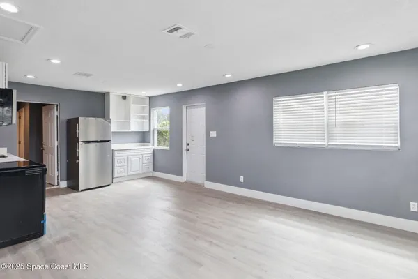 a view of a kitchen with stainless steel appliances