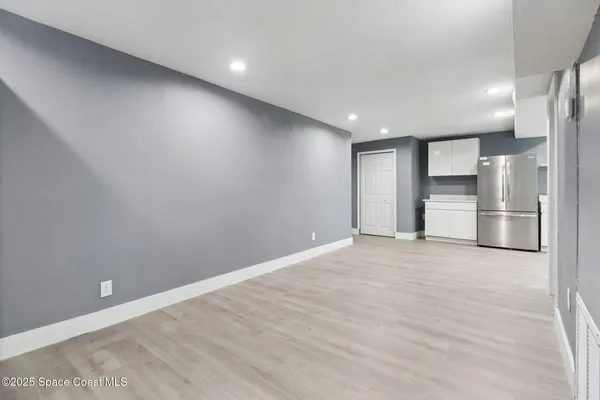 an empty room with closet and windows