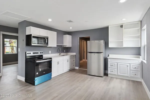 a kitchen with a refrigerator stove and microwave