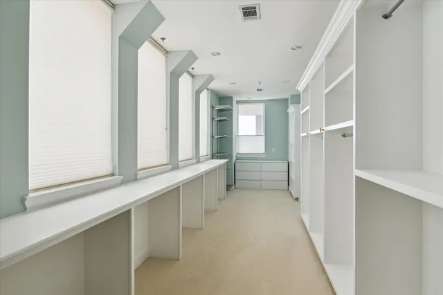 a view of a hallway with windows