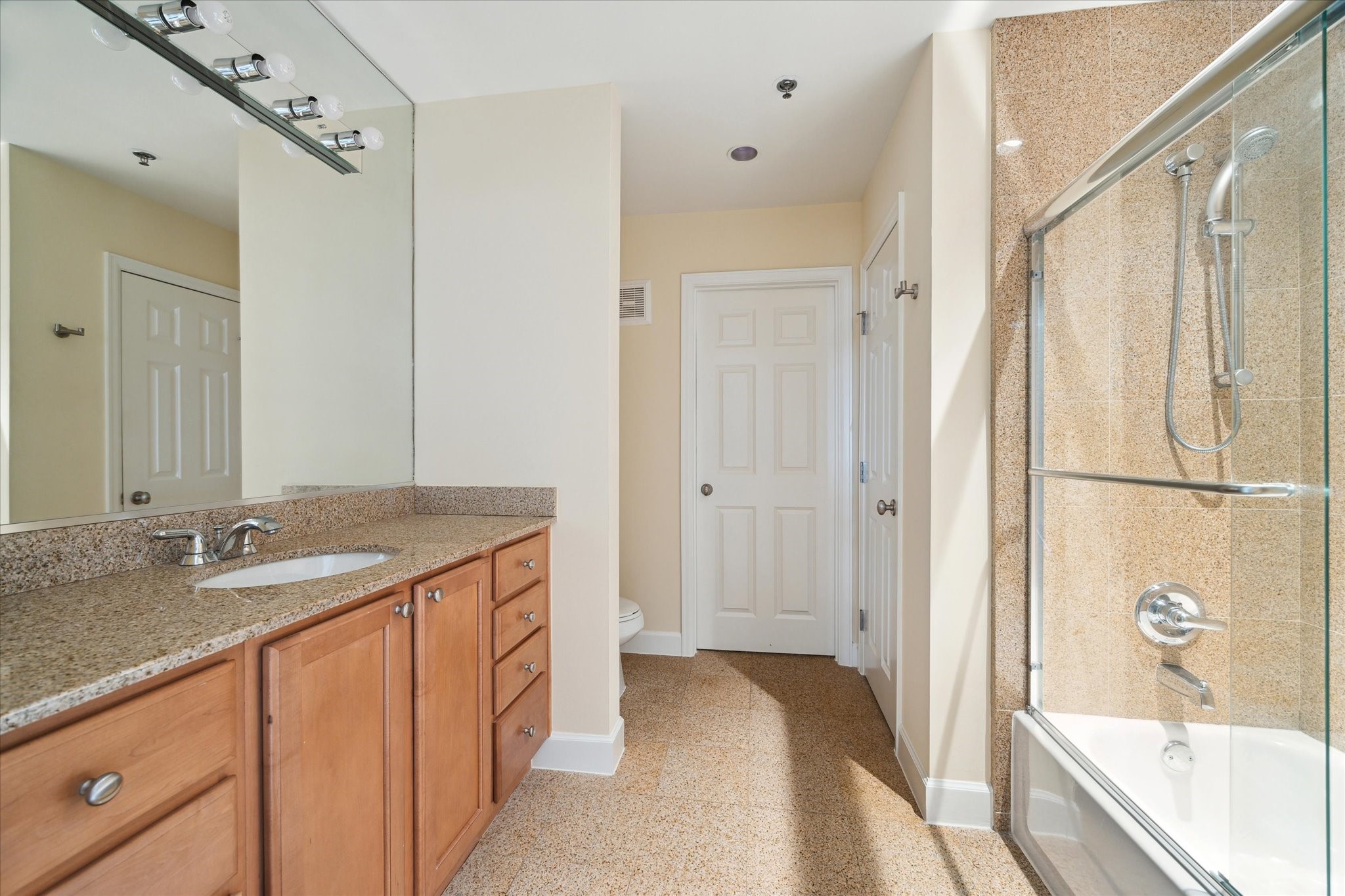 2520 Robinhood Street, Unit 1200 Houston, TX 77005 - Photo 18 of 29 a spacious bathroom with a granite countertop tub sink and mirror