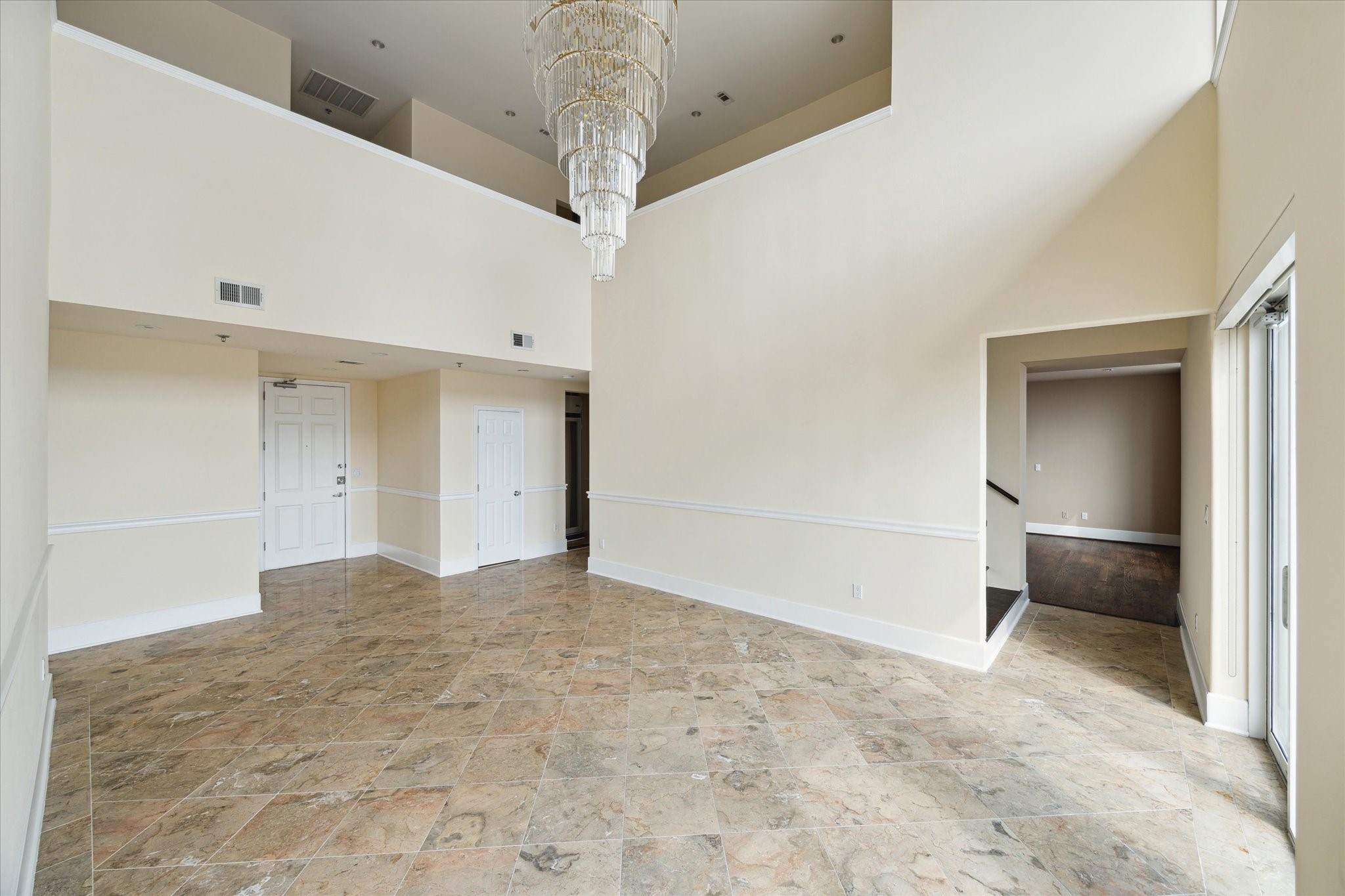 2520 Robinhood Street, Unit 1200 Houston, TX 77005 - Photo 3 of 29 a view of an empty room with a chandelier