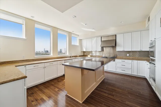 a kitchen with a sink stove and cabinets