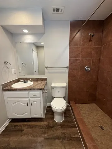 a bathroom with a sink toilet and shower