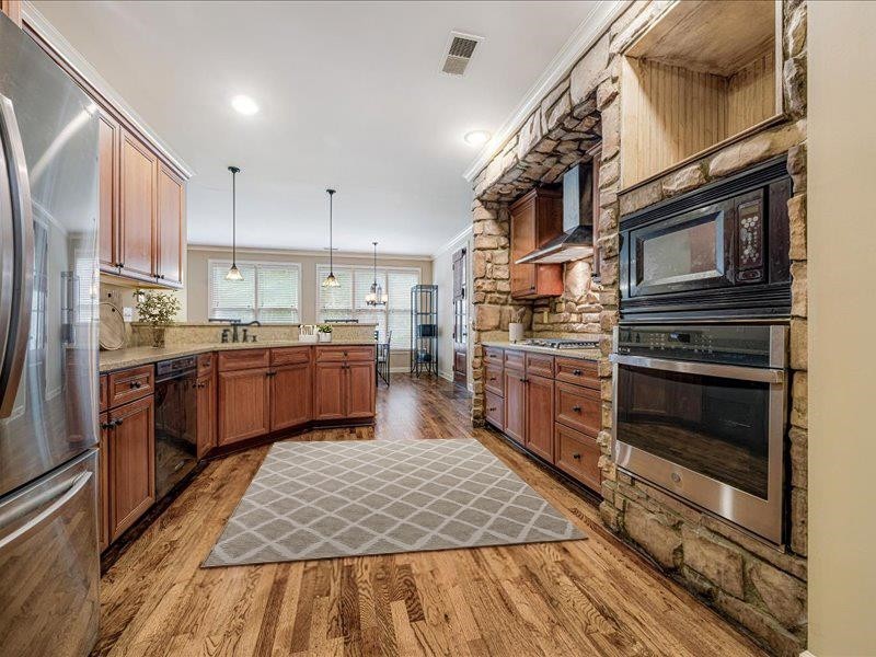 4597 Whisper Spring Drive Collierville, TN 38017 - Photo 6 of 39 a kitchen with lots of counter top space and appliances