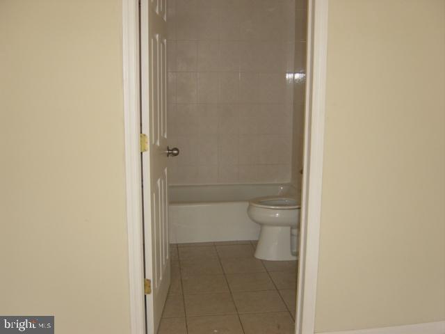 1121 Hamilton Street, Unit A Philadelphia, PA 19123 - Photo 11 of 11 a bathroom with a granite countertop toilet and a shower