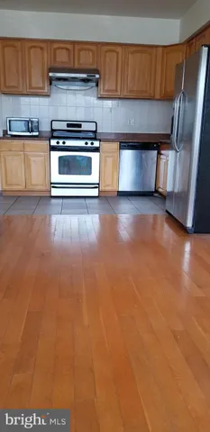a kitchen with a sink and a stove top oven
