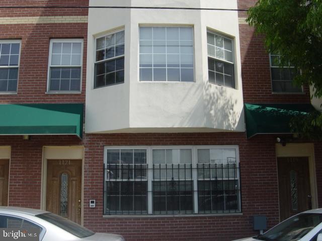 1121 Hamilton Street, Unit A Philadelphia, PA 19123 - Photo 6 of 11 a front view of a house with a yard
