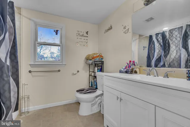 a bathroom with a sink mirror and toilet