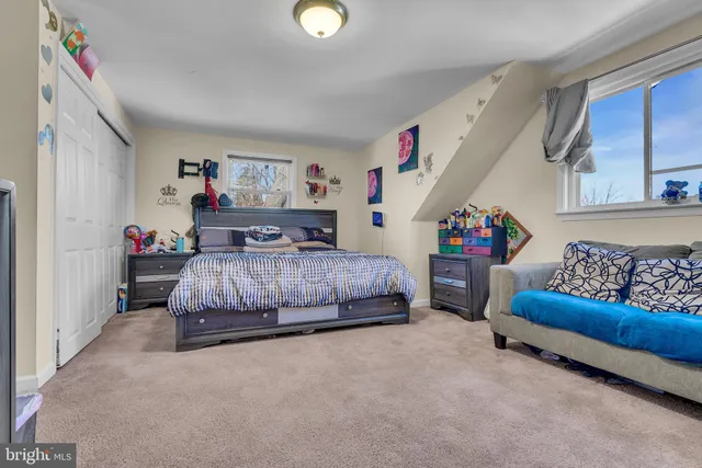 a bedroom with a bed and a couch