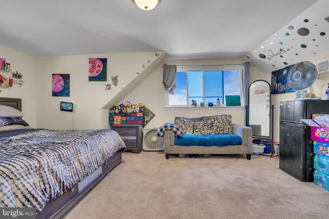 a bedroom with bed and a chandelier