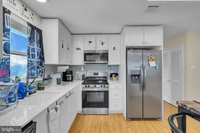 a kitchen with stainless steel appliances a refrigerator stove and sink