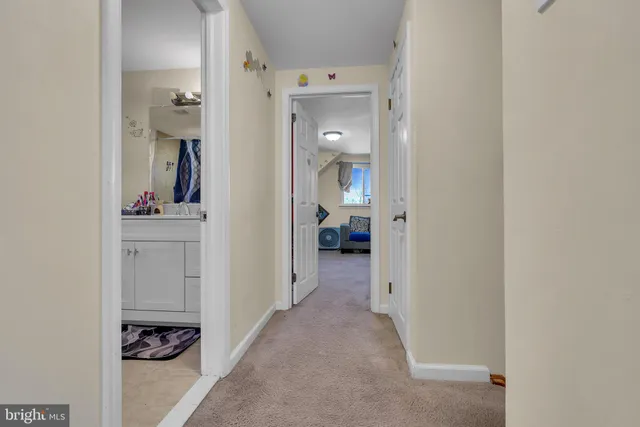 a view of a hallway with closet and wooden floor