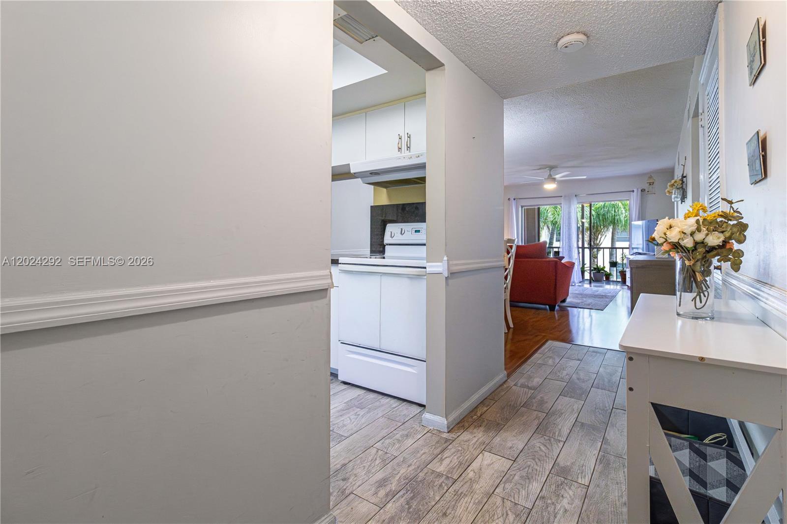 9780 Marina Boulevard, Unit 424 Boca Raton, FL 33428 - Photo 5 of 32 a view of a kitchen with fridge and wooden floor