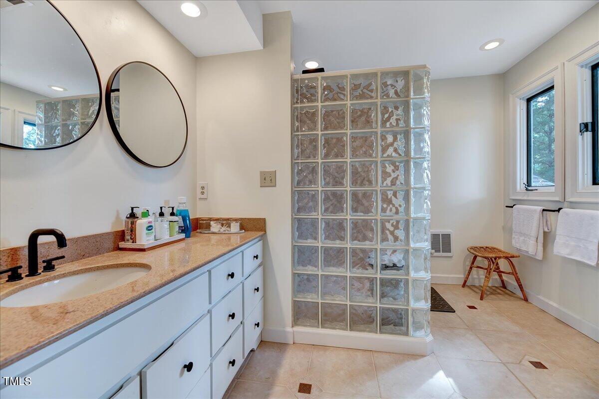 11001 Honeycutt Road Raleigh, NC 27614 - Photo 24 of 36 a bathroom with a double vanity sink and a mirror