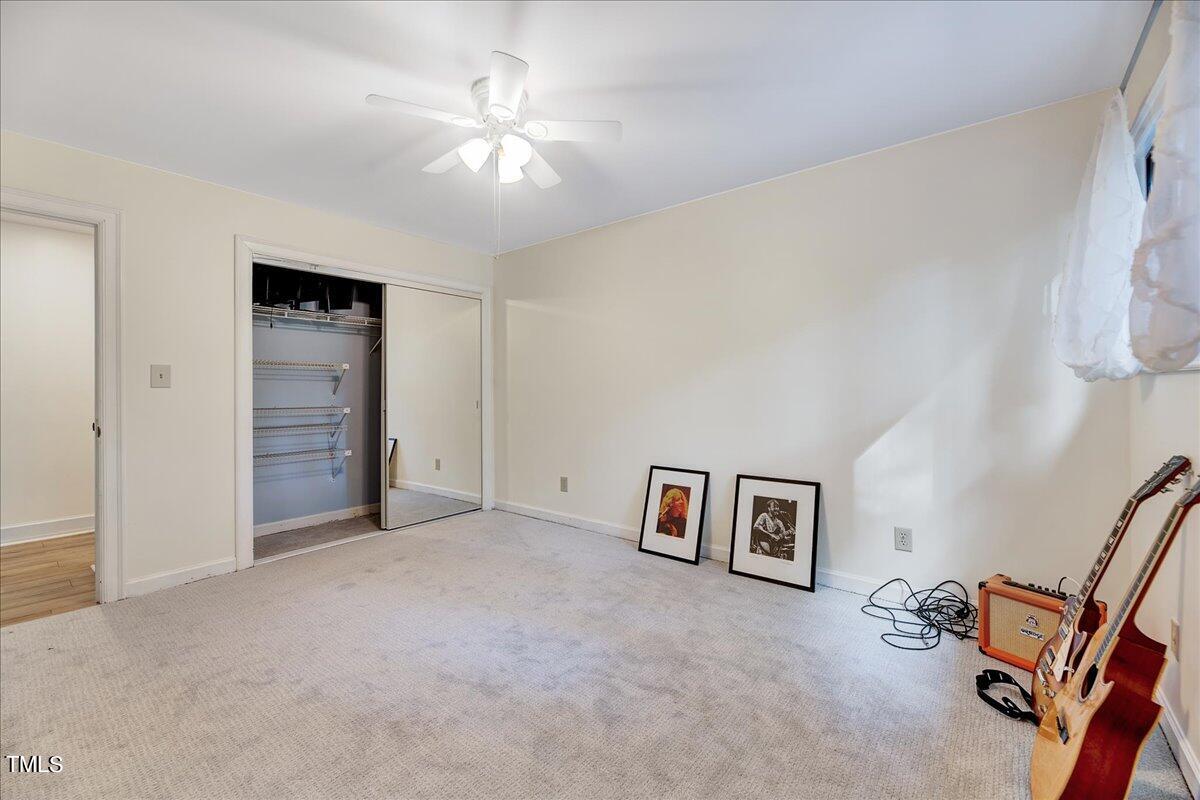 11001 Honeycutt Road Raleigh, NC 27614 - Photo 27 of 36 an empty room with windows and ceiling fan