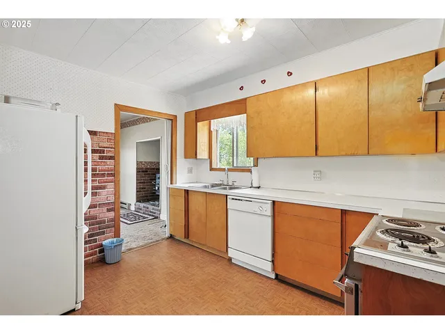 a kitchen with stainless steel appliances granite countertop a sink and a cabinets