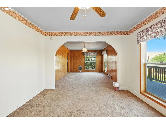 a big room with windows and chandelier