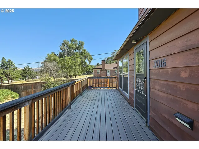 a bedroom with a bed a desk and chair