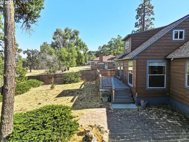 a view of a backyard with a sitting area