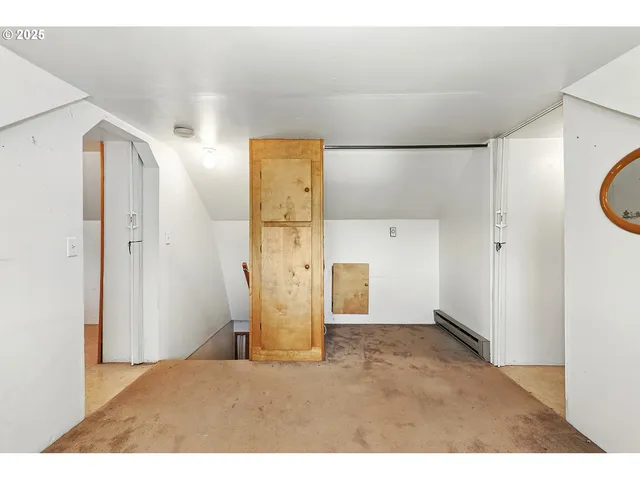a view of a hallway with wooden shelves