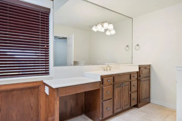 a bathroom with a sink vanity and a mirror