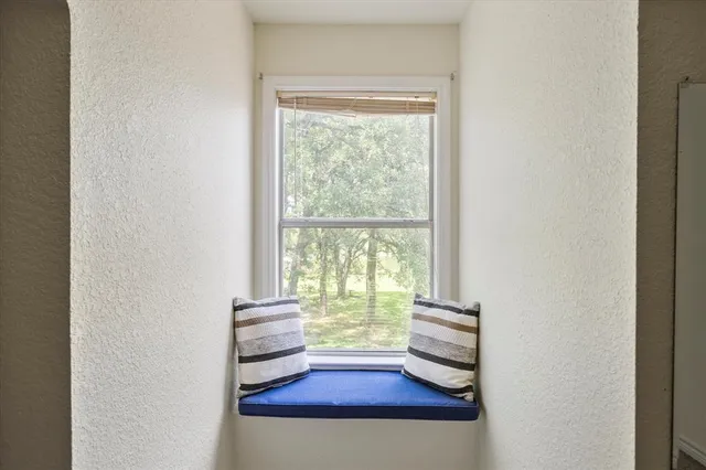 a view of a room with wooden floor and a window