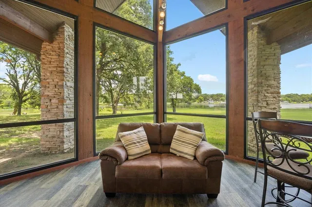 a balcony with furniture and a floor to ceiling window