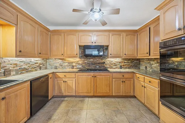 a kitchen with stainless steel appliances granite countertop a stove sink and cabinets