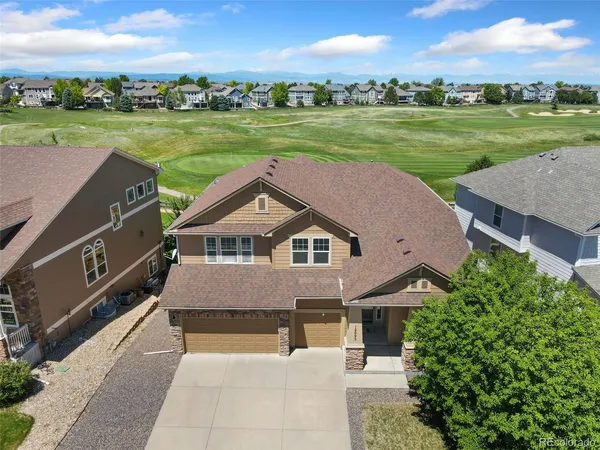 an aerial view of a house with a garden and trees