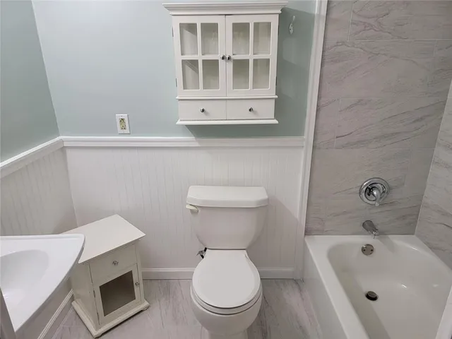a bathroom with a sink a toilet and bathtub