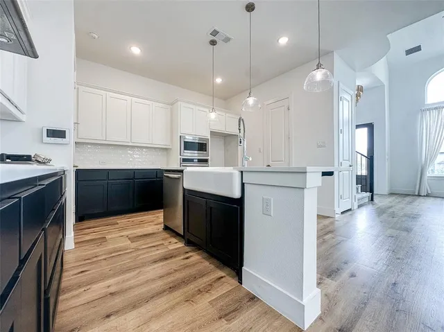 a view of kitchen with sink and wooden floor