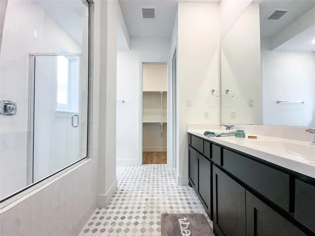 a bathroom with a double vanity sink a and a mirror