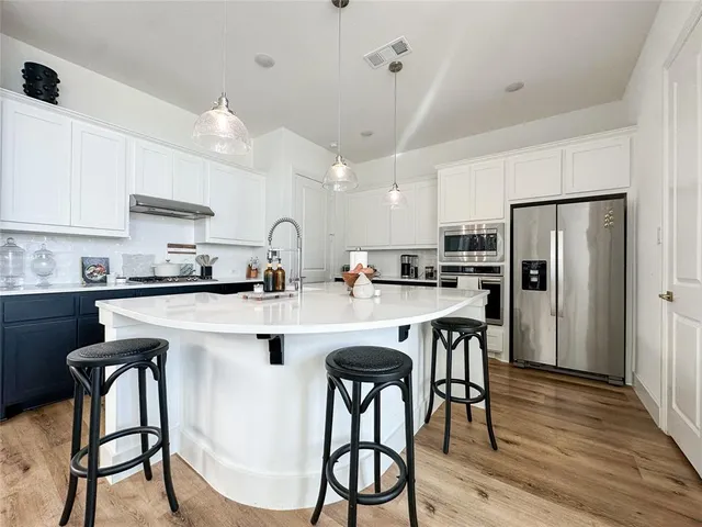 a kitchen with a table and chairs in it