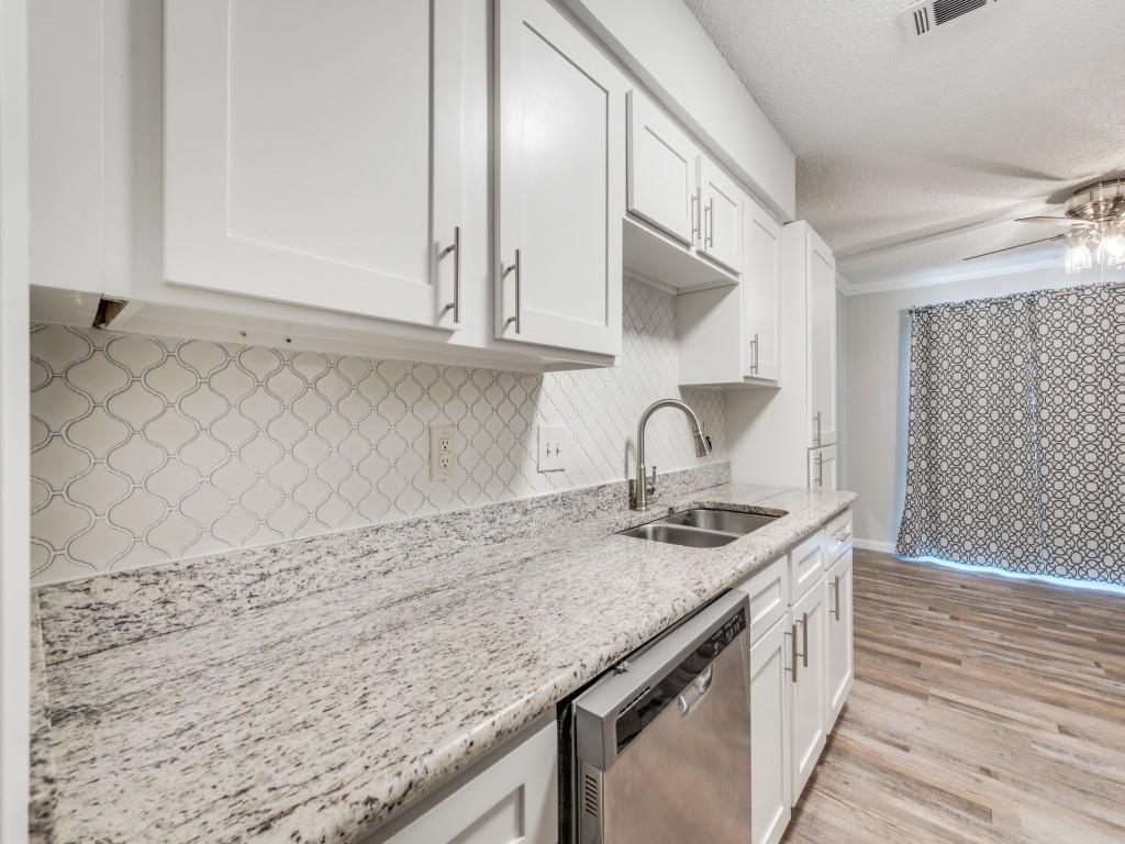 649 Timberline Drive Hurst, TX 76053 - Photo 13 of 29 a kitchen with granite countertop a sink a stove and cabinets