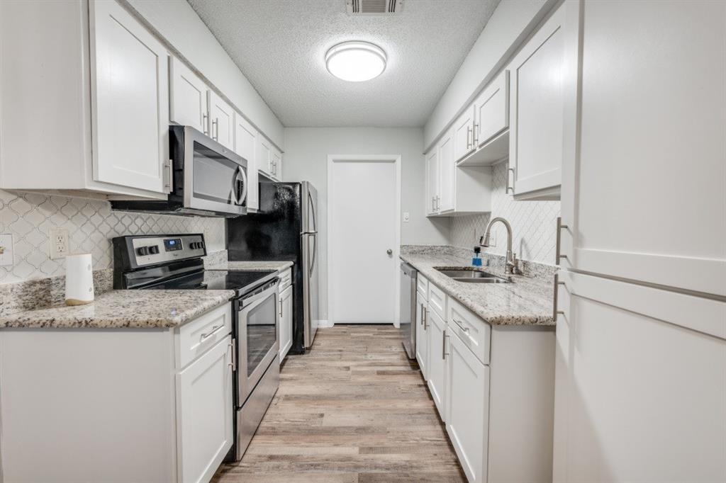 649 Timberline Drive Hurst, TX 76053 - Photo 16 of 29 a kitchen with stainless steel appliances granite countertop a stove top oven a sink and dishwasher